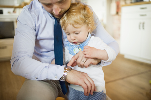 Young father with his son at home playing together.