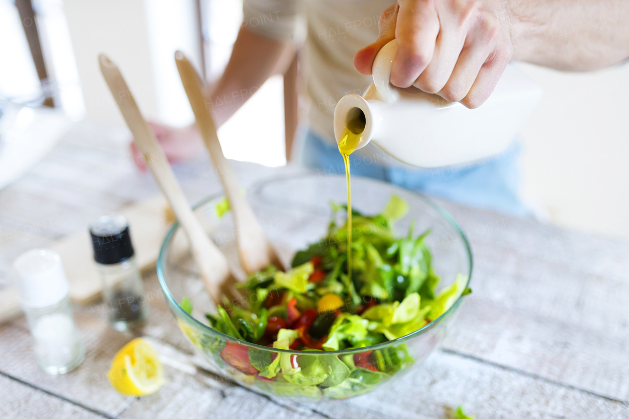 Young man cooking healthy food.