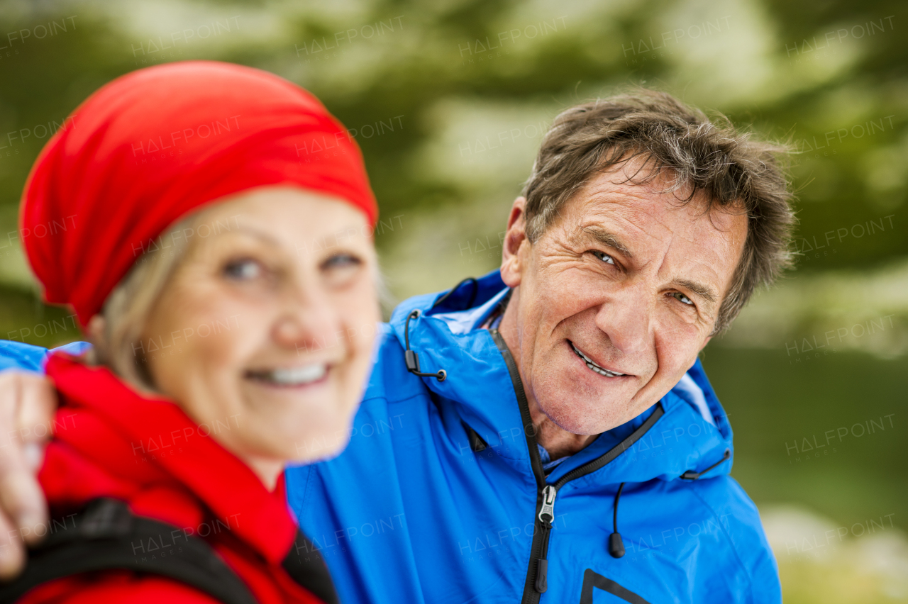 Beautiful senior couple of tourists in the mountains together, spring time.