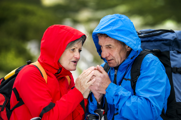 Beautiful senior couple of tourists in the mountains together, spring time.