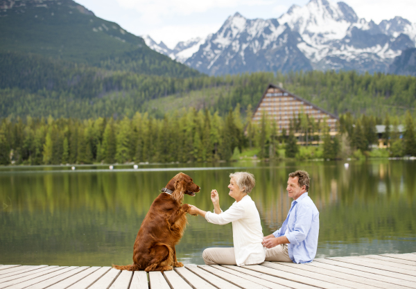 Beautiful senior couple of tourists in the mountains together, spring time.