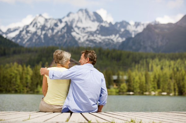 Beautiful senior couple of tourists in the mountains together, spring time.