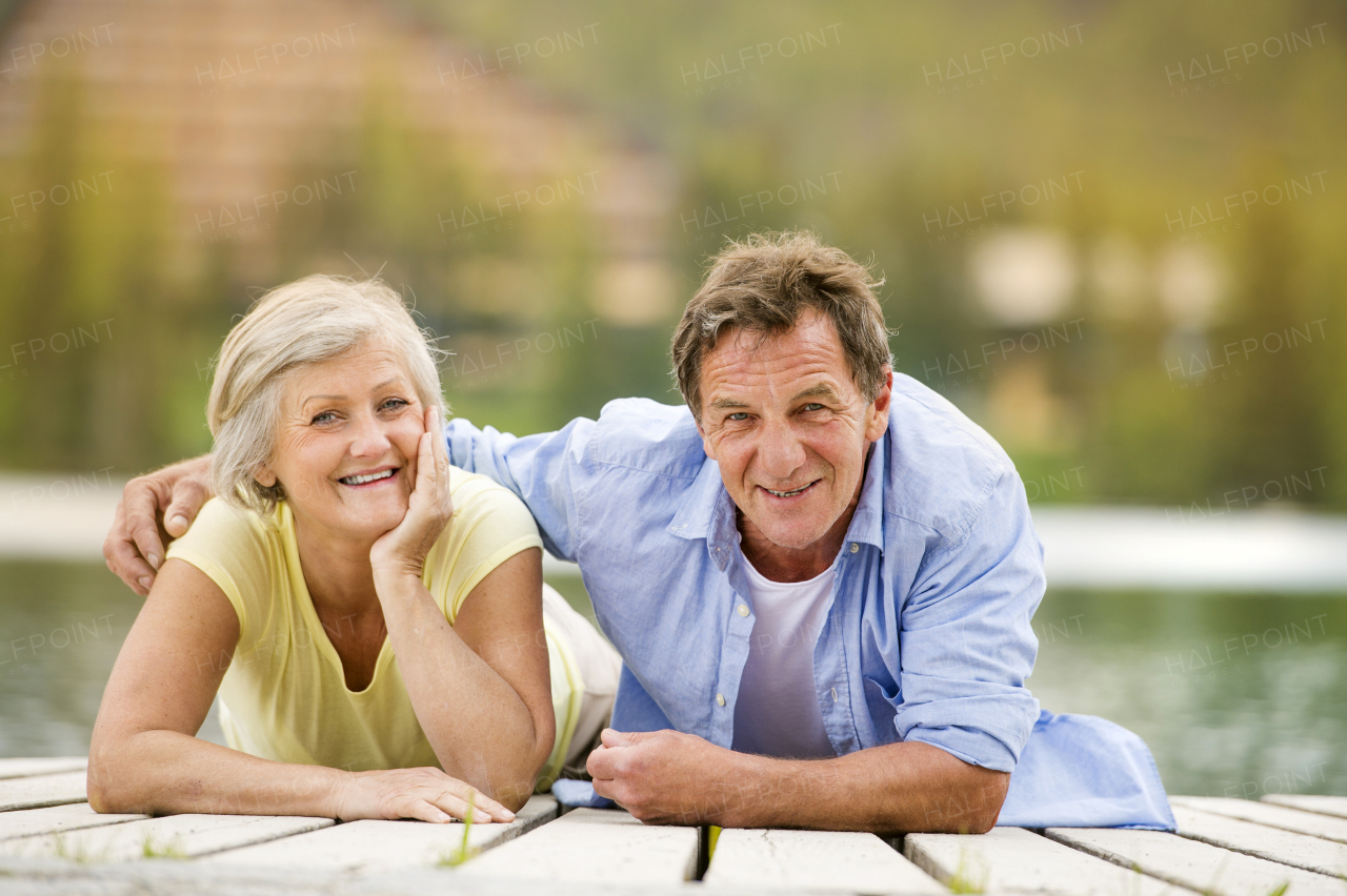 Beautiful senior couple of tourists in the mountains together, spring time.