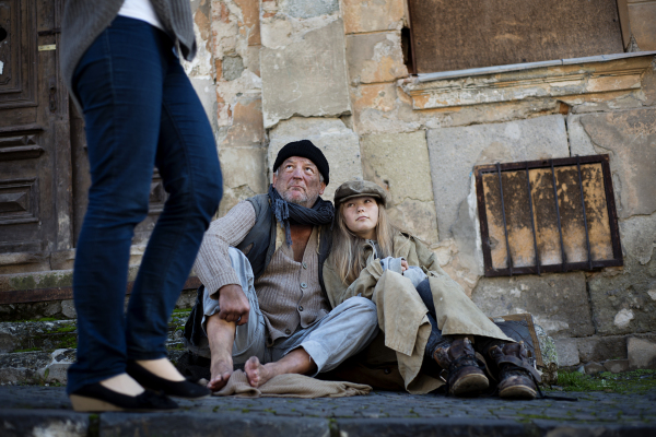 Abandoned people on the street are asking for a money.