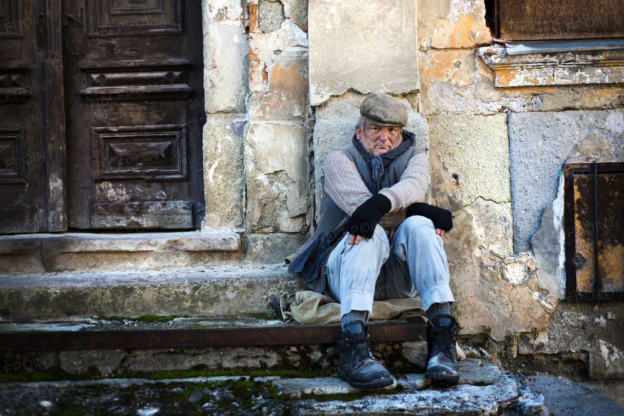 Homeless man in the street feeling cold.