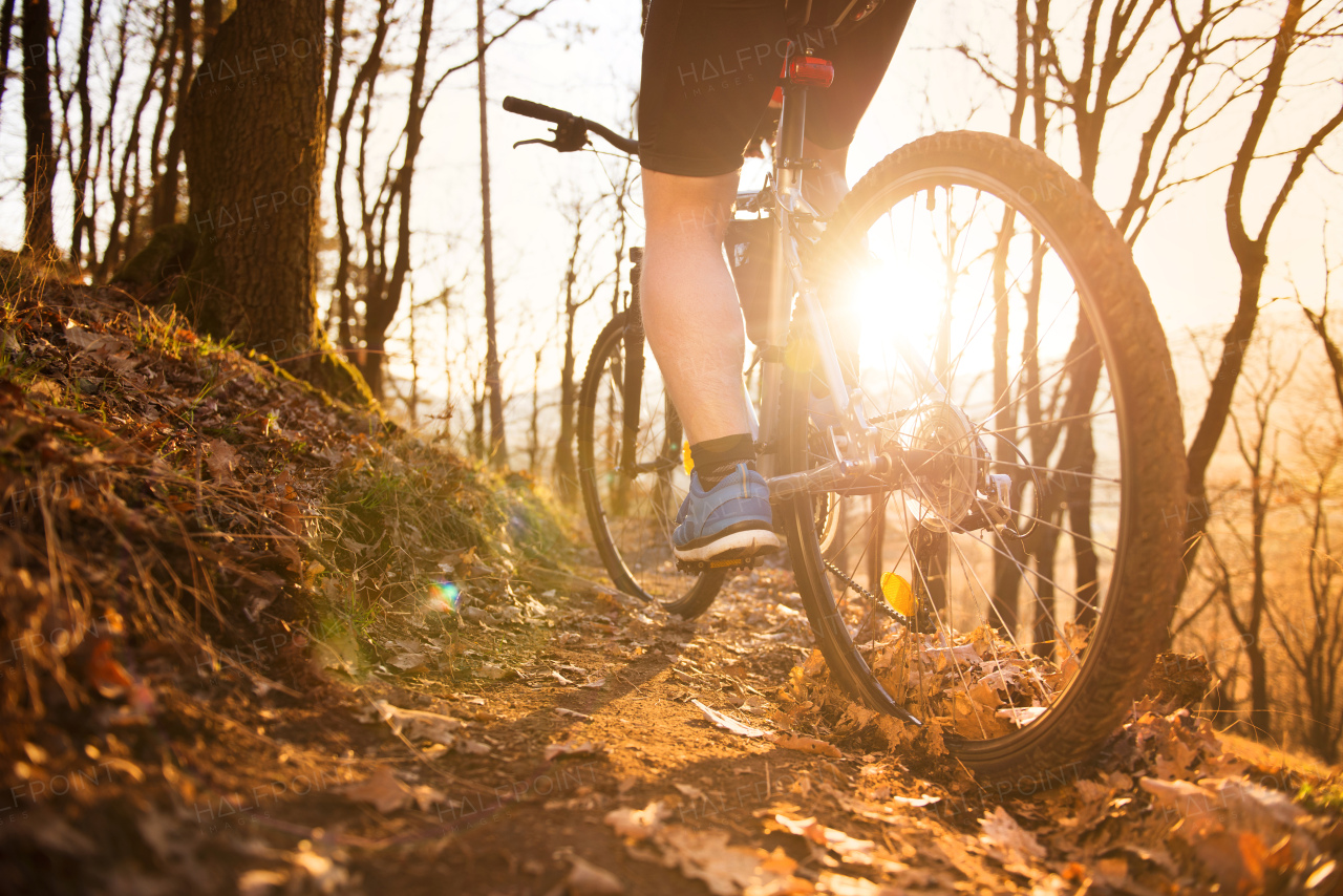 Young handsome man on the bicycle in the mountains.