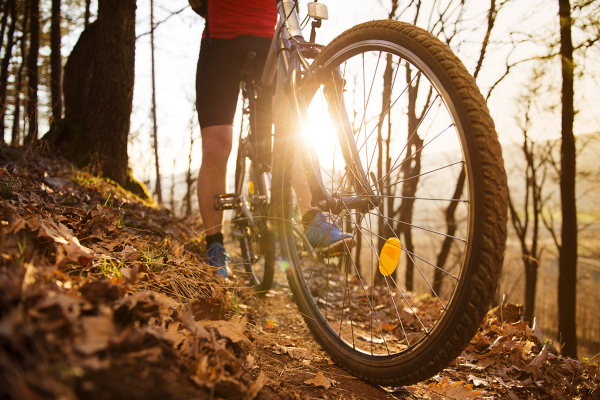 Young handsome man on the bicycle in the mountains.