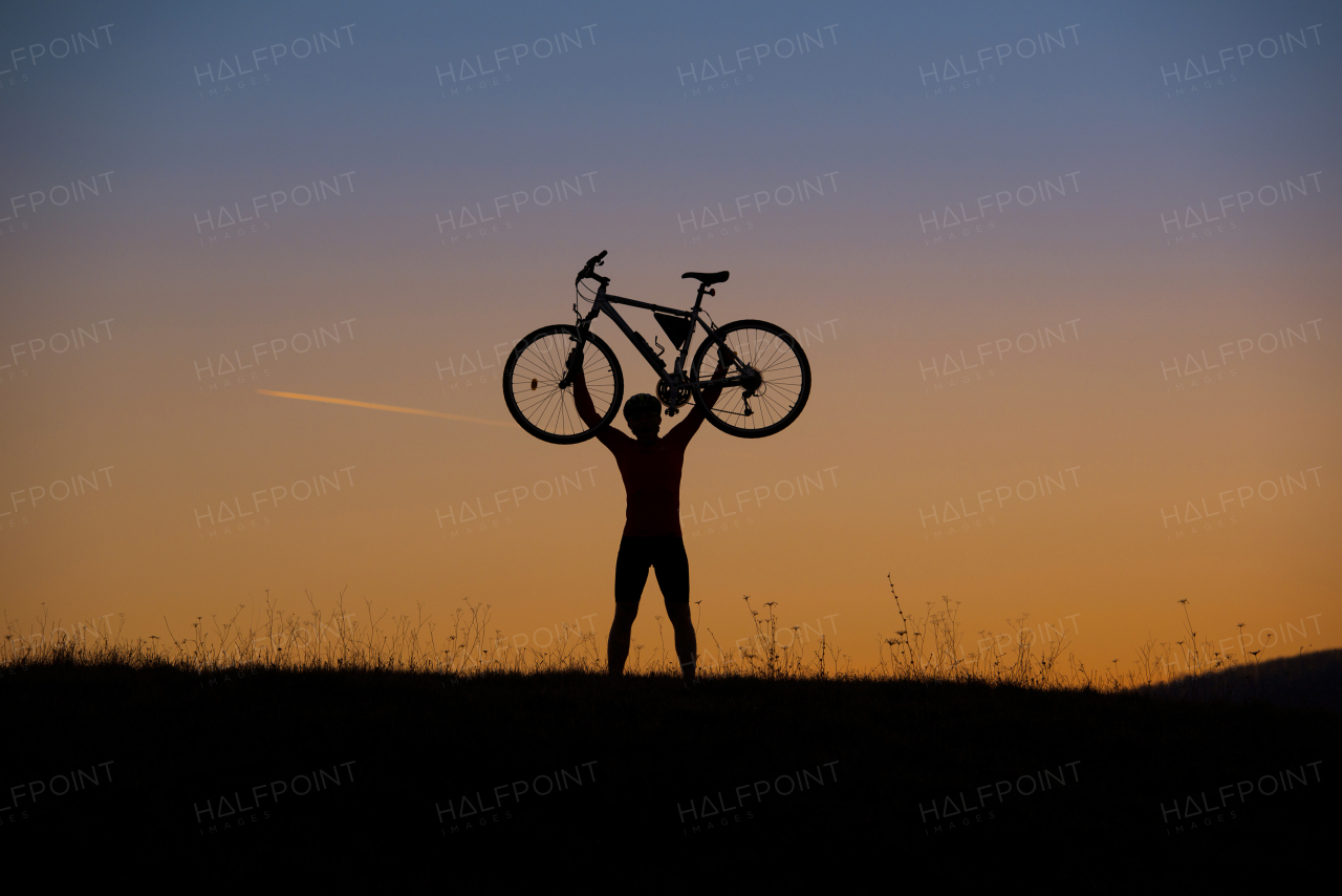 Young handsome man on the bicycle in the mountains.