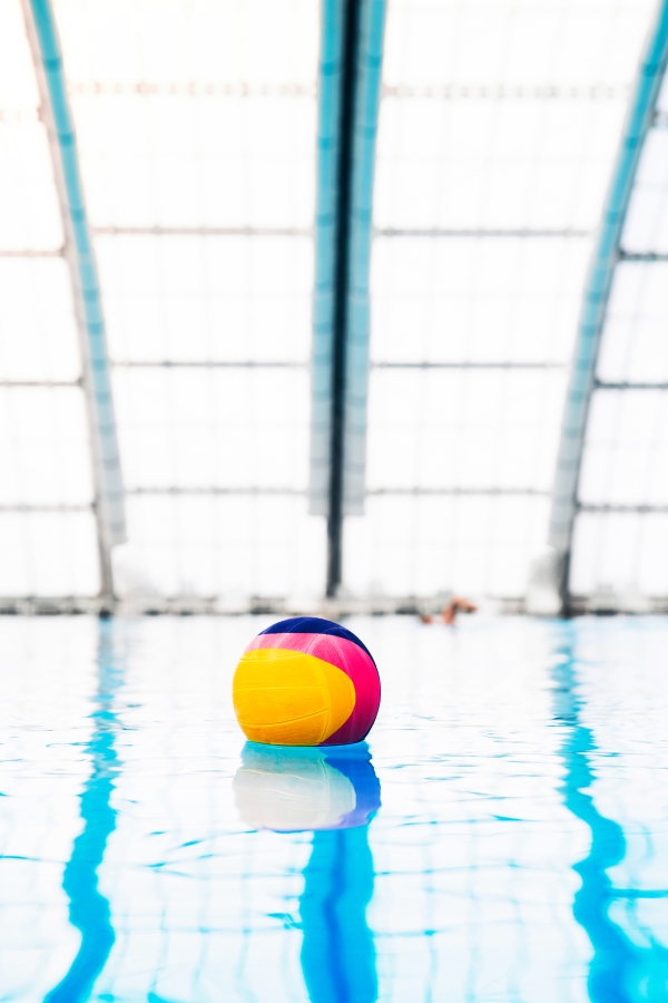 Water polo ball on the water in the indoor swimming pool.