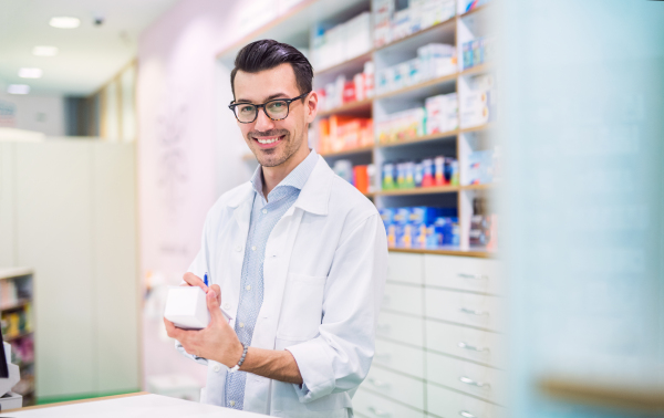 Portrait of a young atrractive friendly male pharmacist.