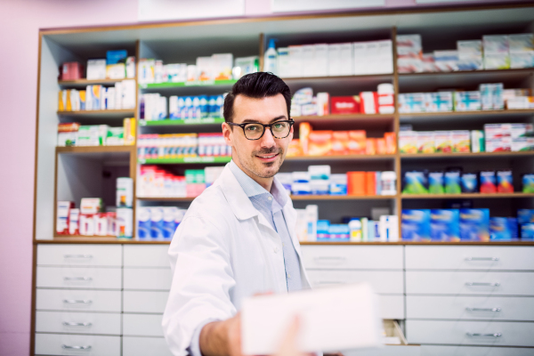 Portrait of a young atrractive friendly male pharmacist.