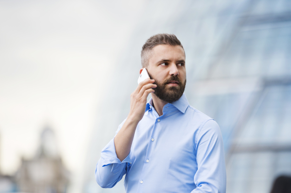 Handsome young man with smartphone in the streets of London