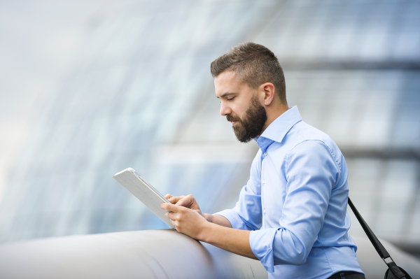 Handsome young man with tablet in the streets of London