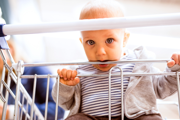 Unrecognizable young mother with her little baby boy at the supermarket, shopping. Close up.