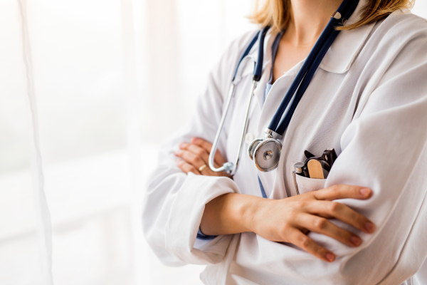 Portrait of an unrecognizable young female doctor with crossed arms.