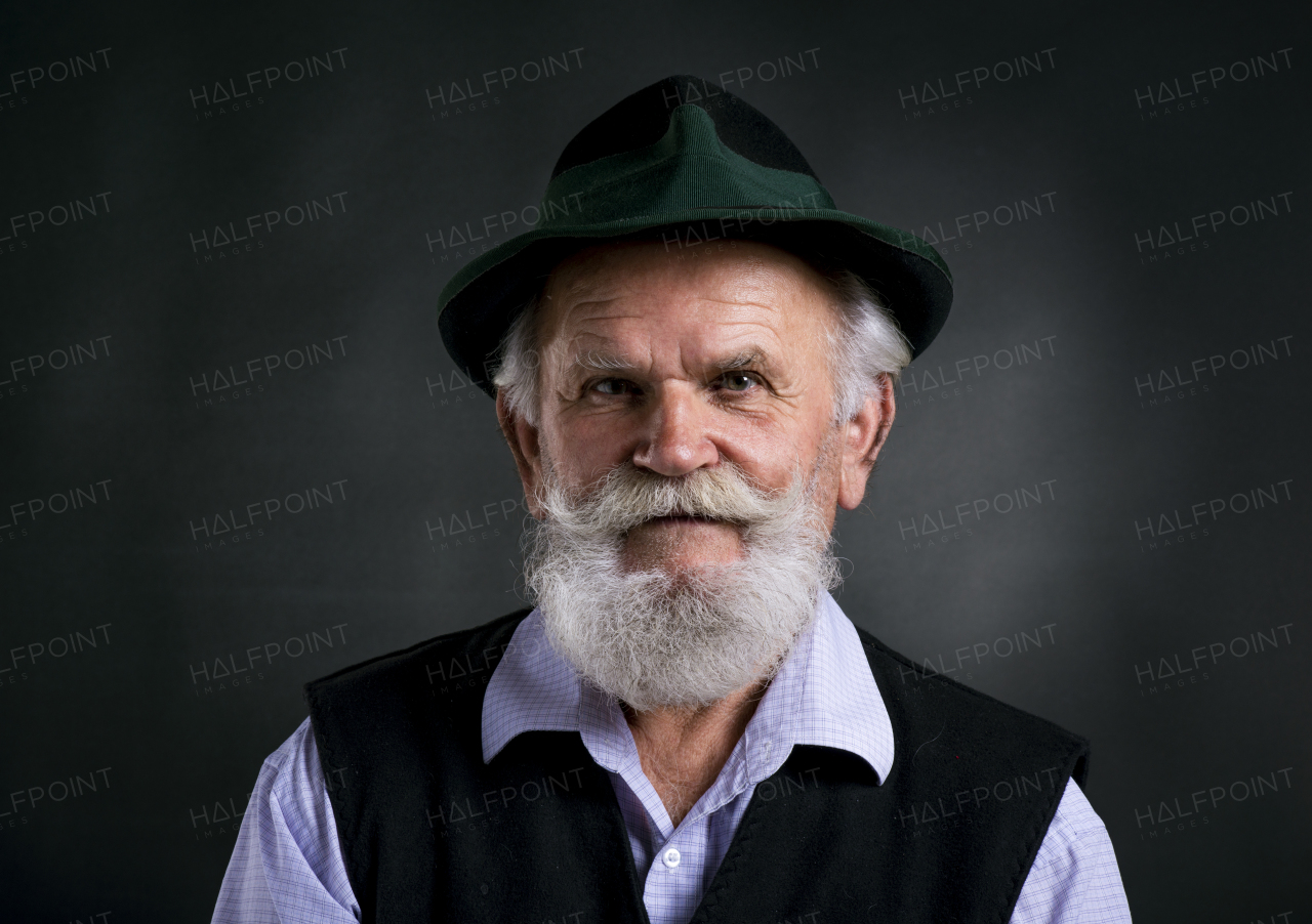 Studio shot of old beaked man.