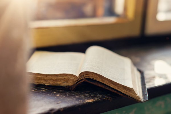 Close up of an old prayer book laid on windowsill