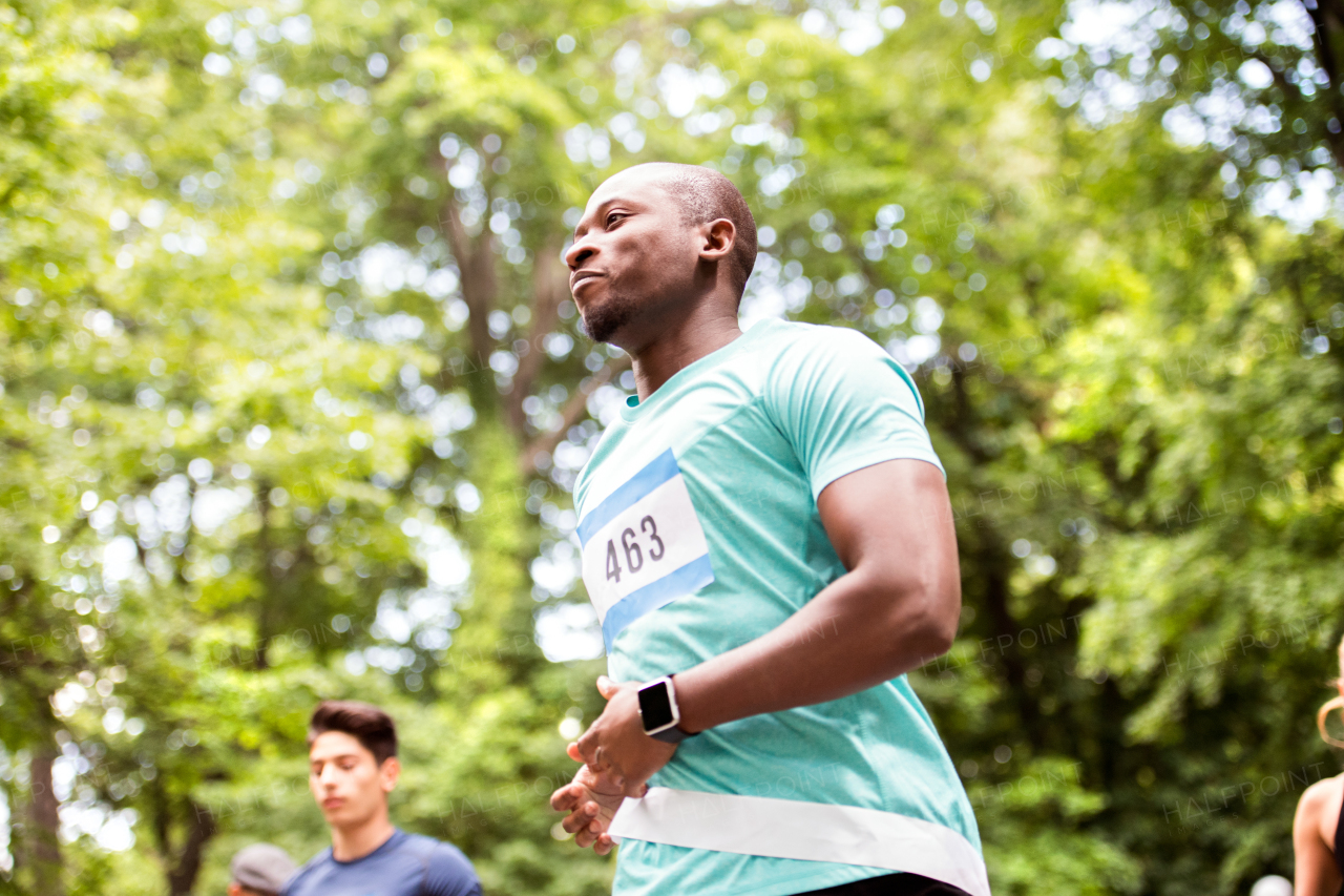 Young fit afro-american man on a race crossing the finish line.