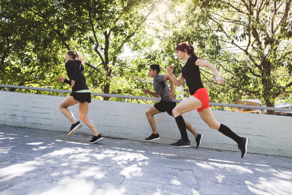 Beautiful young athletes running in the city.