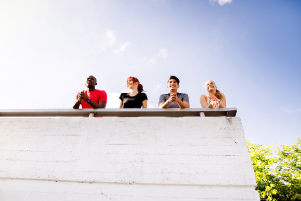 Group of beautiful young athletes running in the city, resting.