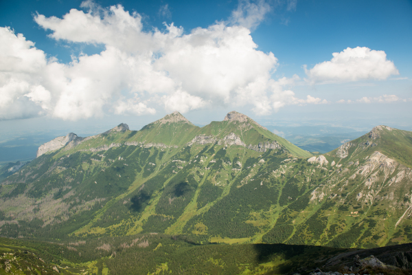 Scenery of high green mountains, blue sky with clouds. High Tatras Slovakia. Beautiful mountain landscape.