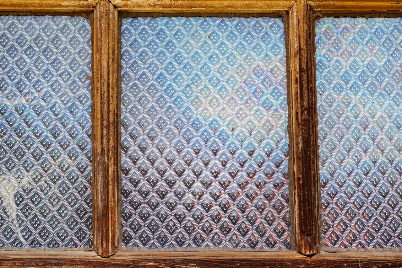 Close up of vintage old window frame with glass panels with pattern