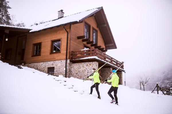 Active senior couple going cross-country skiing. Winter time.