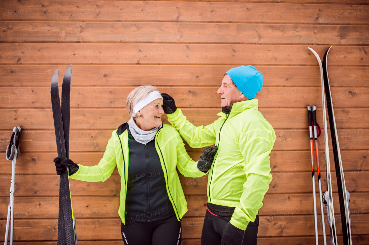 Active senior couple getting ready for cross-country skiing. Winter time.