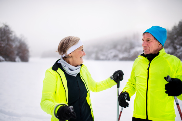 Active senior couple cross-country skiing. Winter time.