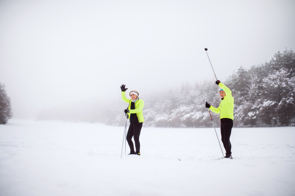 Active senior couple cross-country skiing. Winter time.