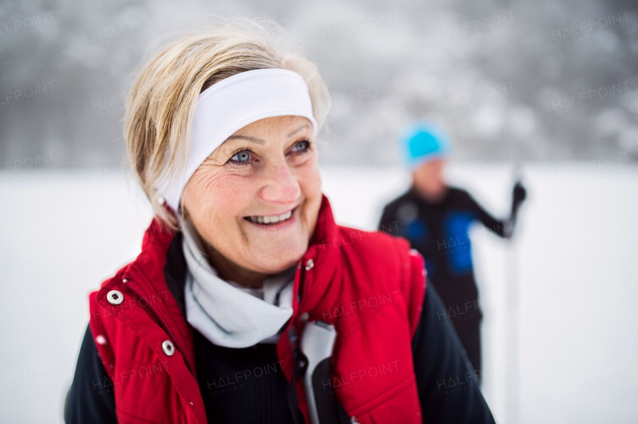 Active senior couple cross-country skiing. Winter time.