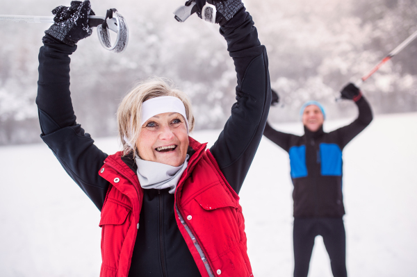 Active senior couple cross-country skiing. Winter time.