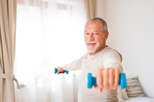 Active senior man doing exercise at home.