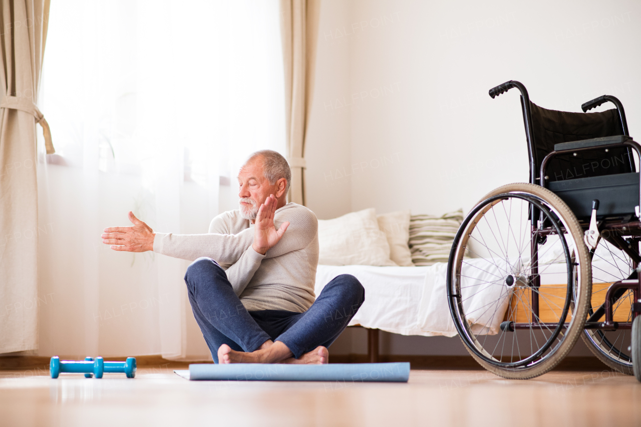 Active senior man doing exercise at home.