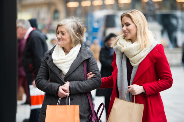 Two beautiful women, mother and daughter, window shopping in historical centre of the city of Vienna, Austria. Winter.