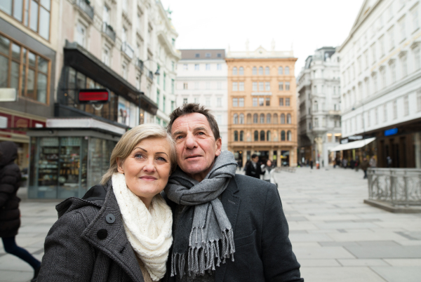 Beautiful senior couple on a walk in historical centre of the city of Vienna, Austria. Winter.