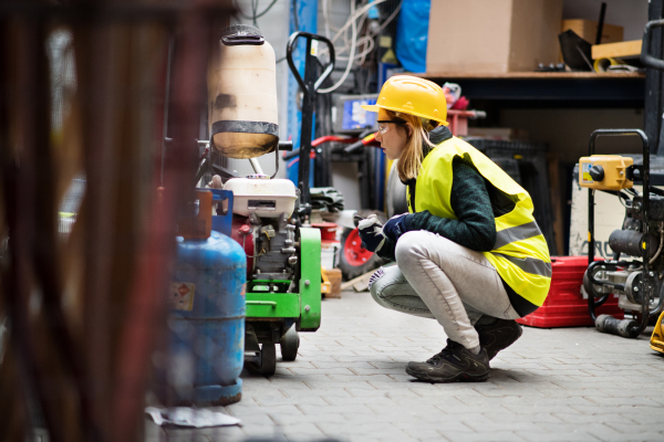 Beautiful young female worker in a warehouse.