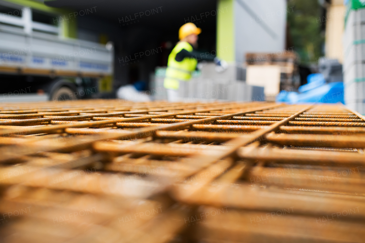 Female worker in an industrial area. Beautiful young woman working outside warehouse building.