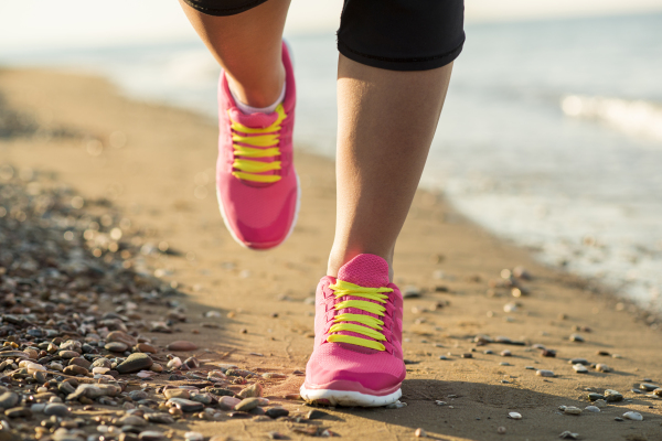 Woman running on the beach.