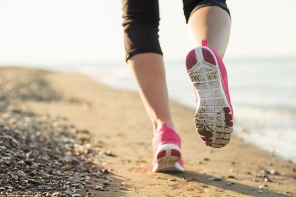 Woman running on the beach.