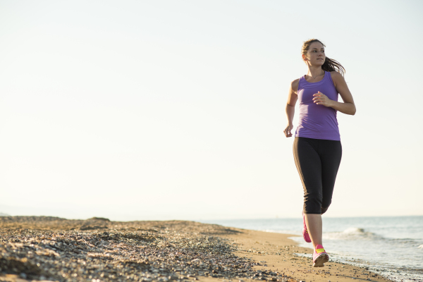 Woman running on the beach.