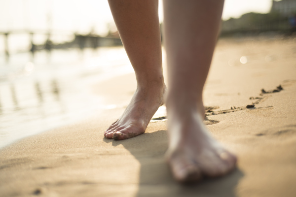 Young beautiful woman on the beach, summer time.