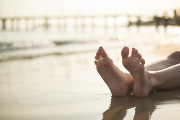 Young beautiful woman on the beach, summer time.