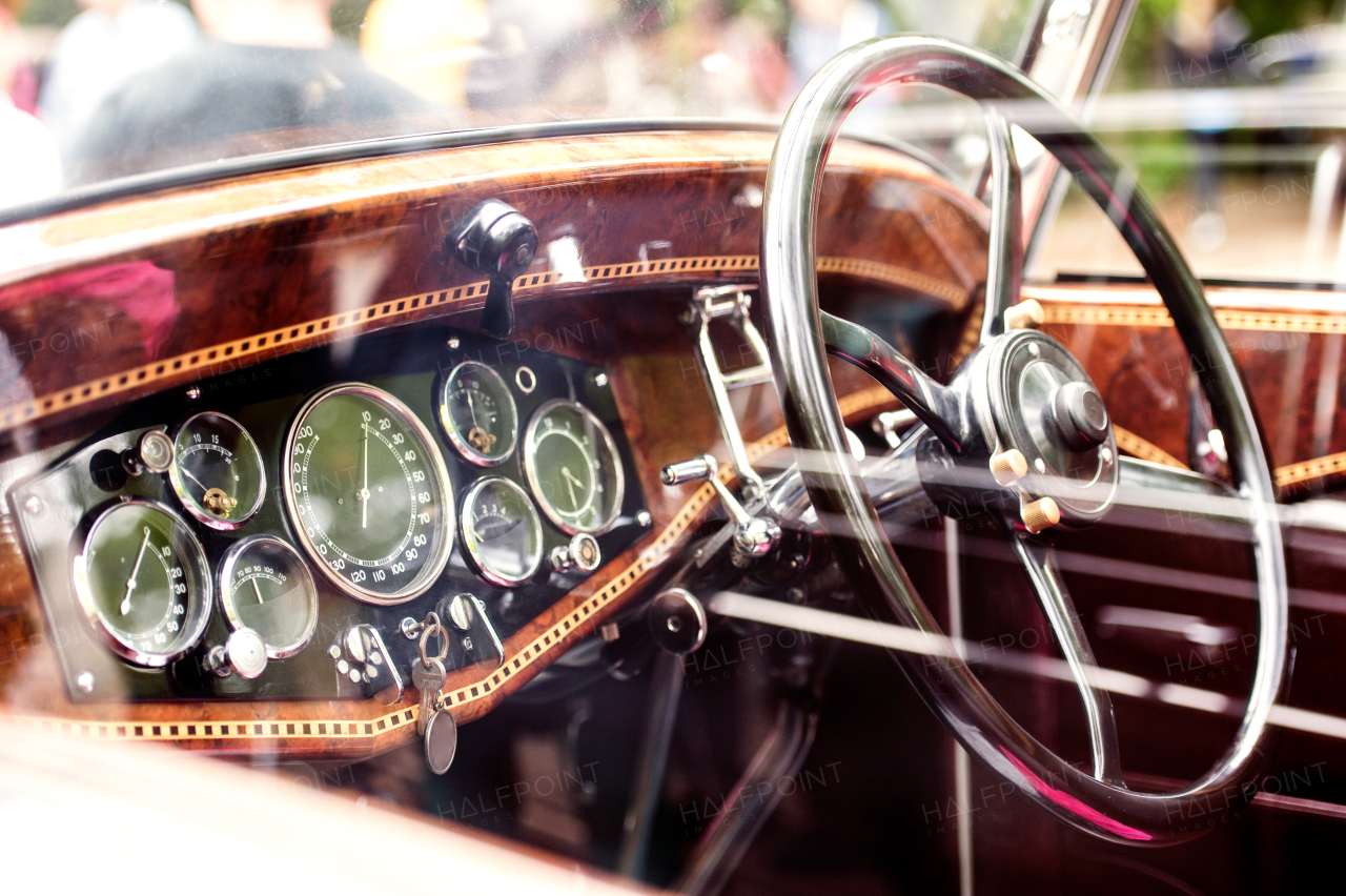 Close up of veteran car, dashboard, windshield, steering wheel, sunny summer day