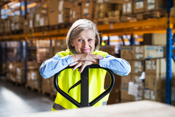 Portrait of a senior woman worker or supervisor in a warehouse.