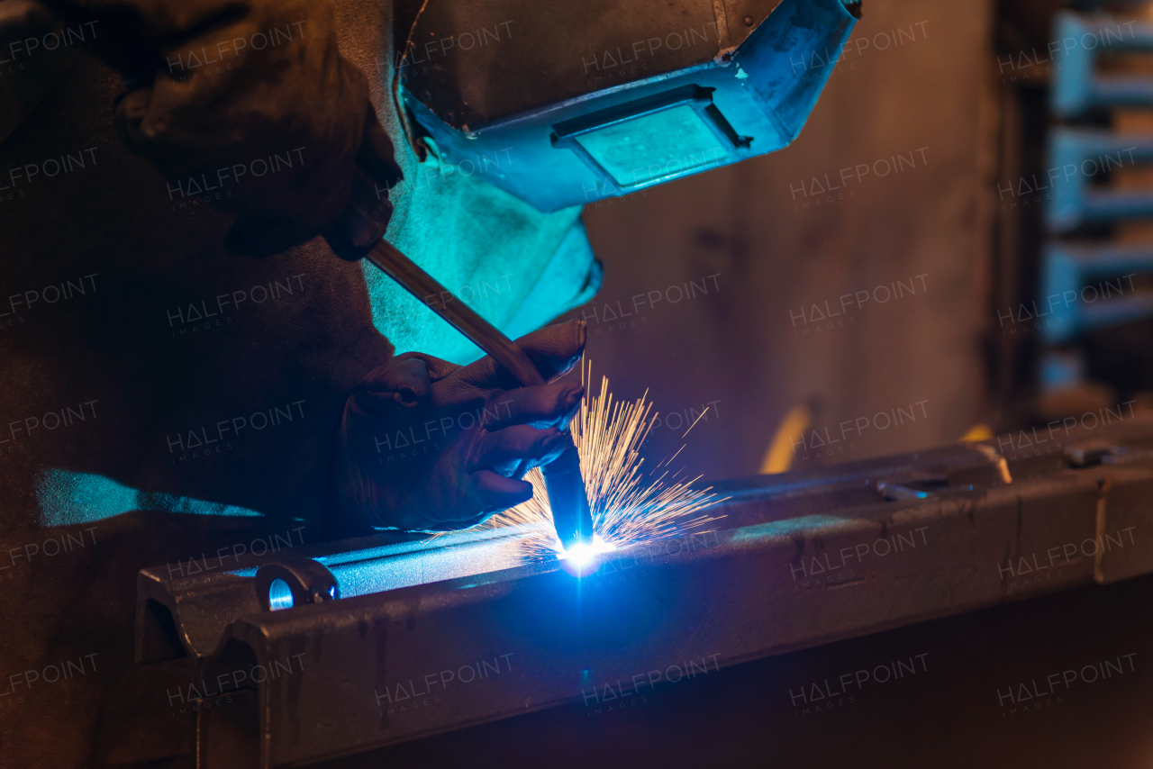 Young beautiful welder in the factory, hard working.