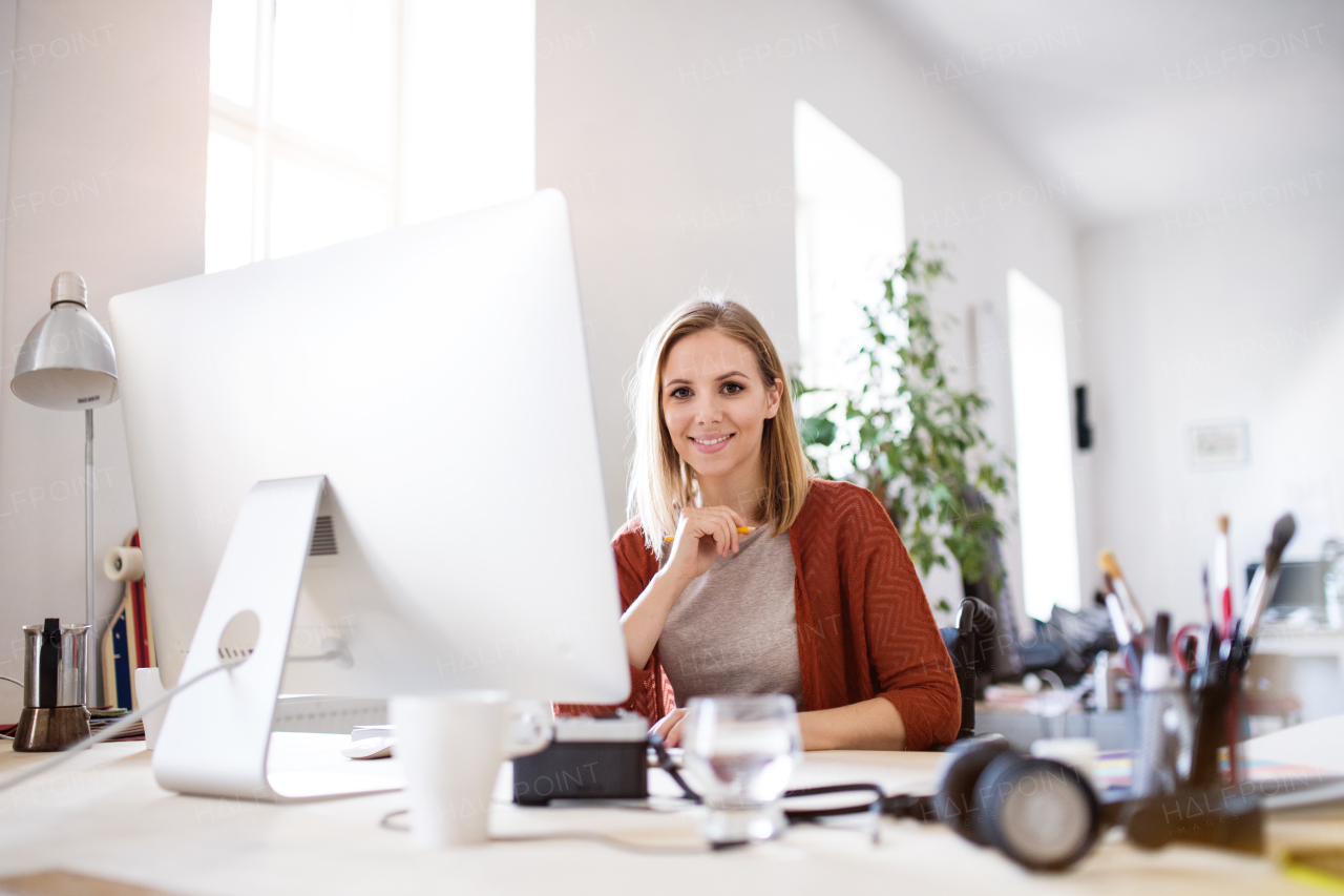 Businesswoman in wheelchair sitting at the desk, working.