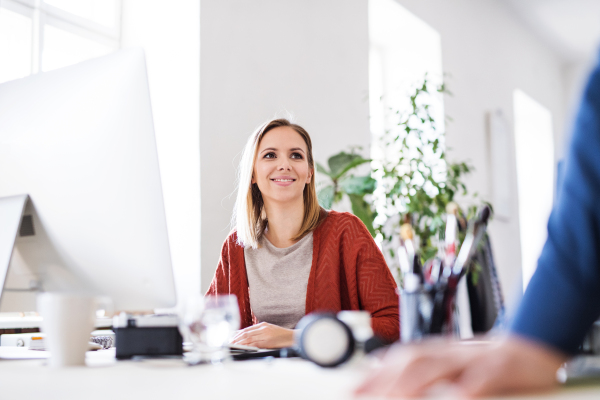 Portrait of a young businesswoman sitting at the desk.