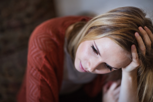 Beautiful young woman feeling tired and unhappy. Close up.