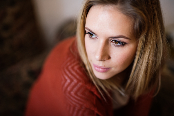 Beautiful young woman feeling tired and unhappy. Close up.